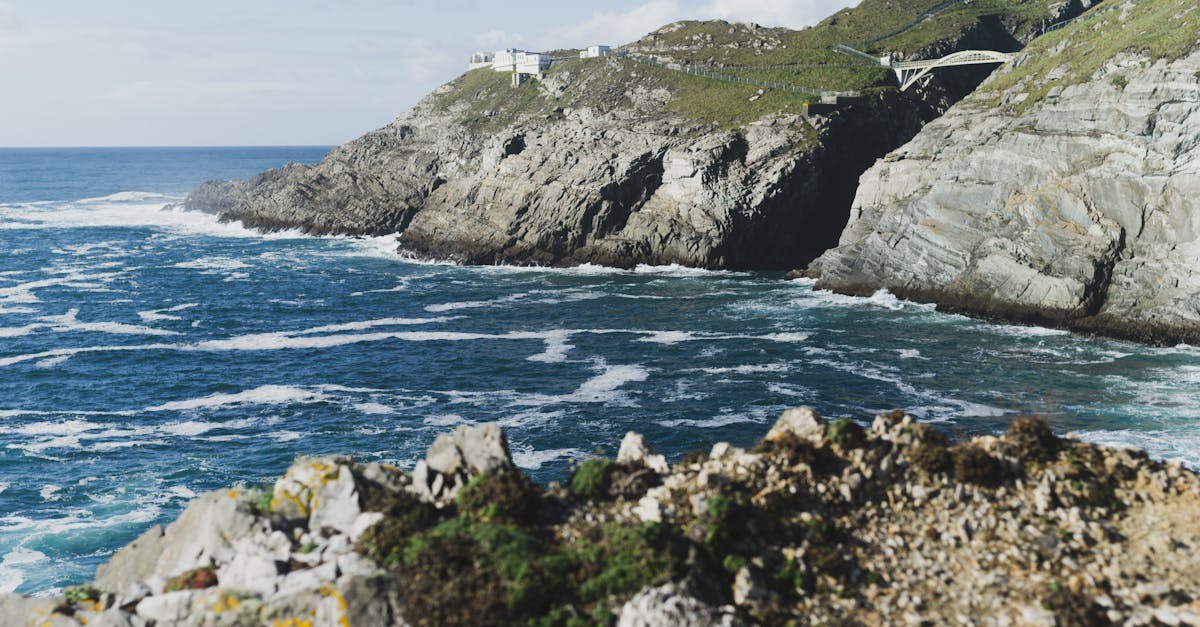Majestic rocky cliffs overlooking the deep blue ocean on a sunny day.