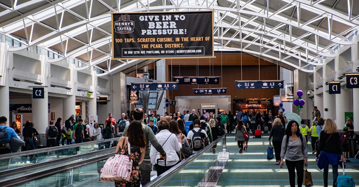 Crowds of people walking through a modern airport terminal, vibrant travel atmosphere.