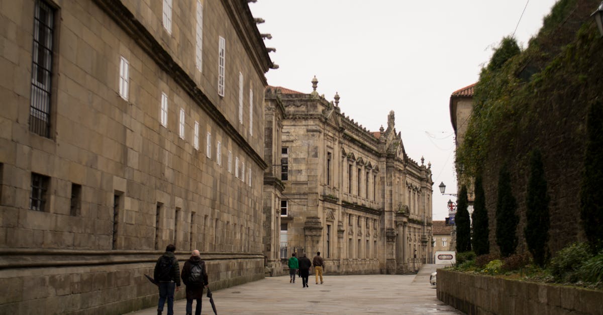 People walking along a historical street in Santiago de Compostela, Spain.