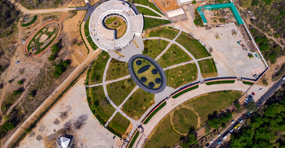 Drone shot capturing an aerial view of a park with circular designs and green landscaping.