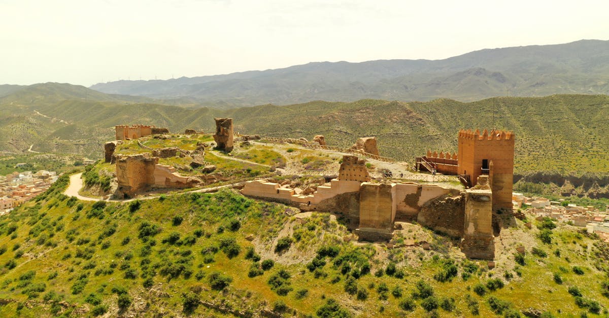 Explore the ancient ruins of Castillo de Tabernas set against a stunning mountain backdrop.