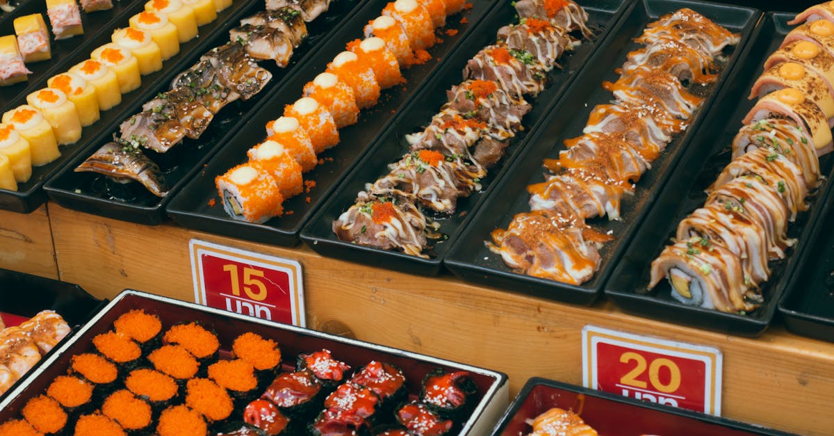 A colorful array of sushi platters at a buffet, showcasing assorted rolls and seafood delicacies.