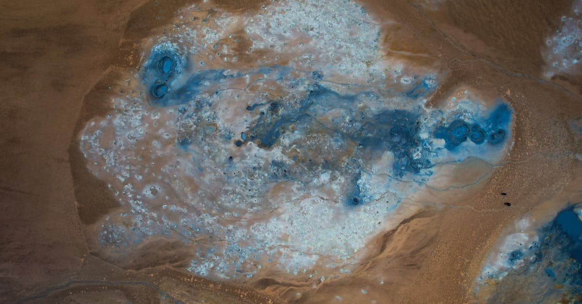 Stunning aerial view of Reykjahlíð's geothermal landscape with vivid blue mineral deposits.
