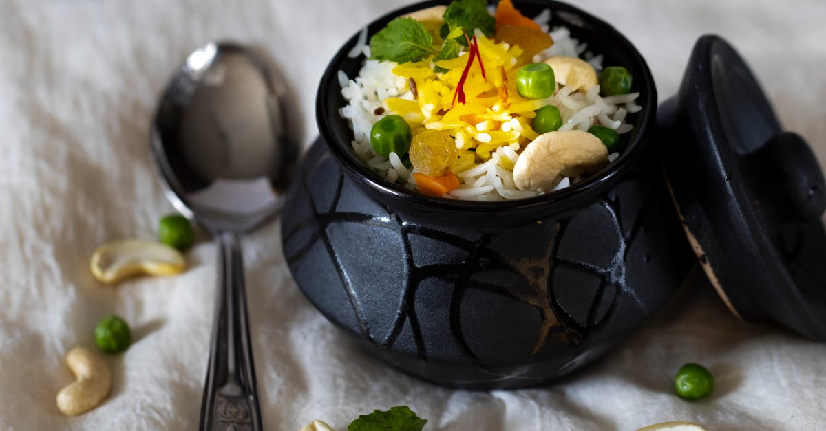 Authentic Indian rice with peas, cashews, and saffron in a black pot. Perfect for culinary themes.