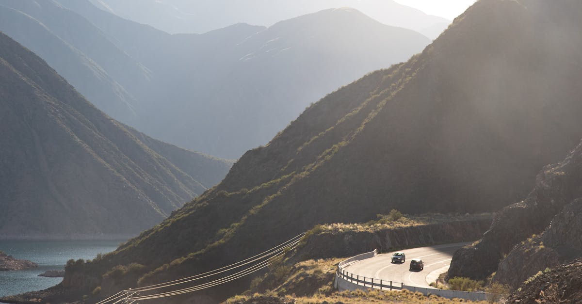 Winding road through the Andes in Atuel Sud, Mendoza, Argentina with fog and mountains.