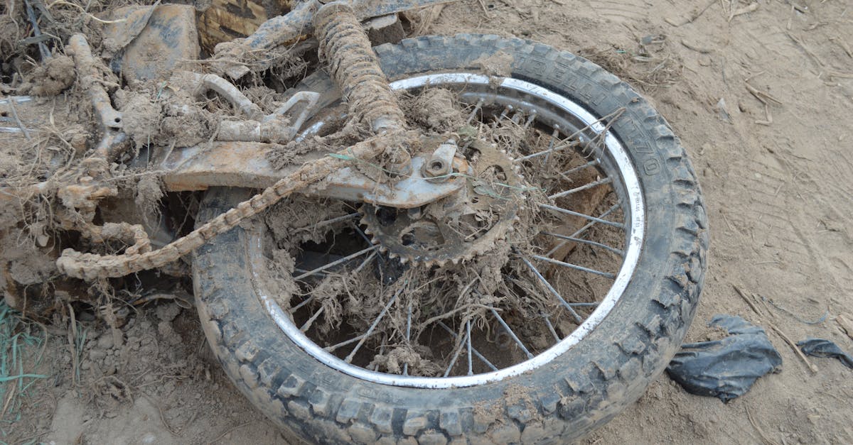 Close-up of an abandoned motorcycle tire covered in mud, located in Mocoa, Colombia.