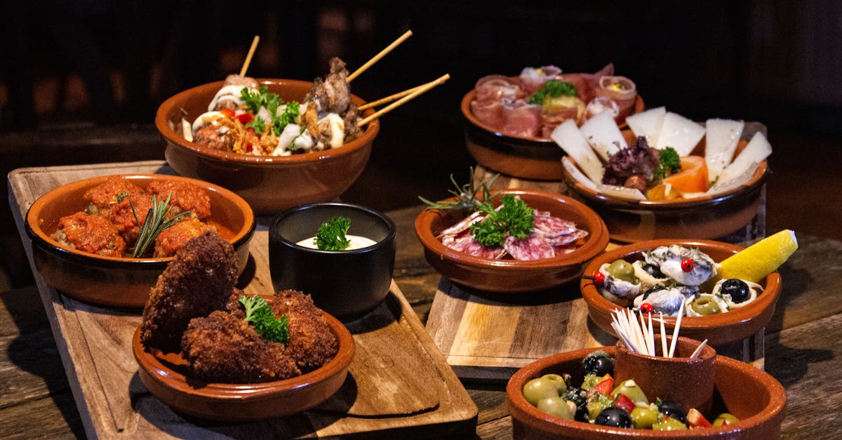 Assorted Spanish tapas dishes served in rustic style on a wooden table.