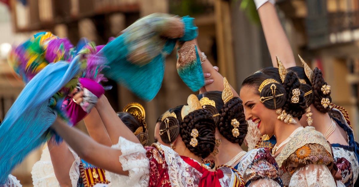 Women in traditional Spanish attire celebrate a cultural festival in Valencia with vibrant dances and festive spirit.