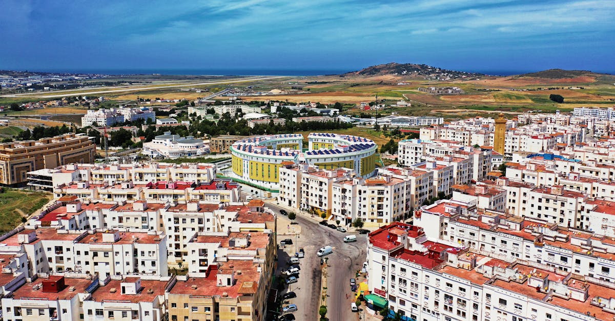 Drone shot of Tanger cityscape, residential buildings, and coastal view in Morocco.