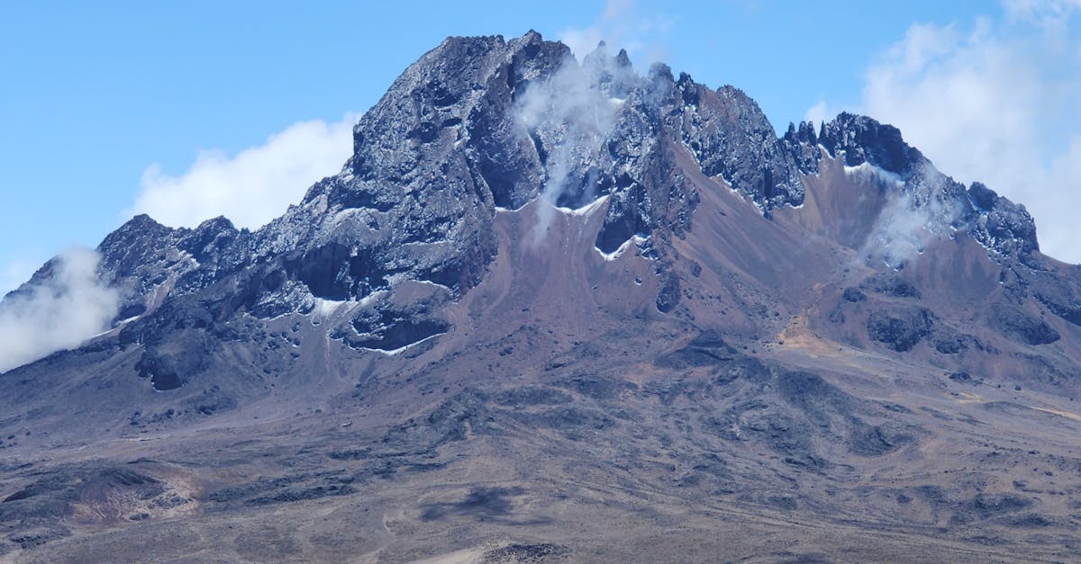 Stunning view of Gilman's Point, Mount Kilimanjaro showcasing rugged landscapes and rocky peaks.