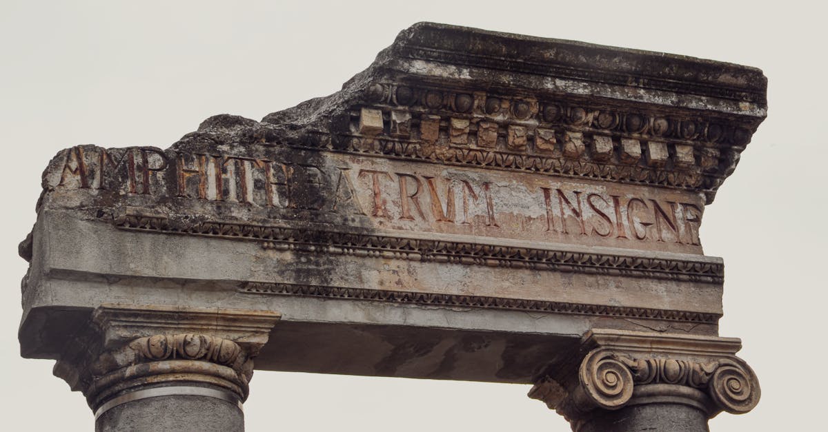 Close-up of ancient Roman ruins in Sicilì, Italy showcasing detailed stone columns and inscriptions.