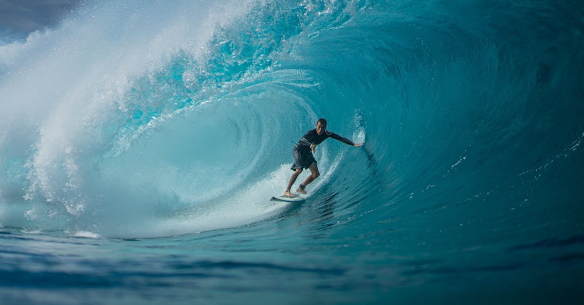 A surfer skillfully rides a massive ocean wave, capturing the thrill and essence of water sports.