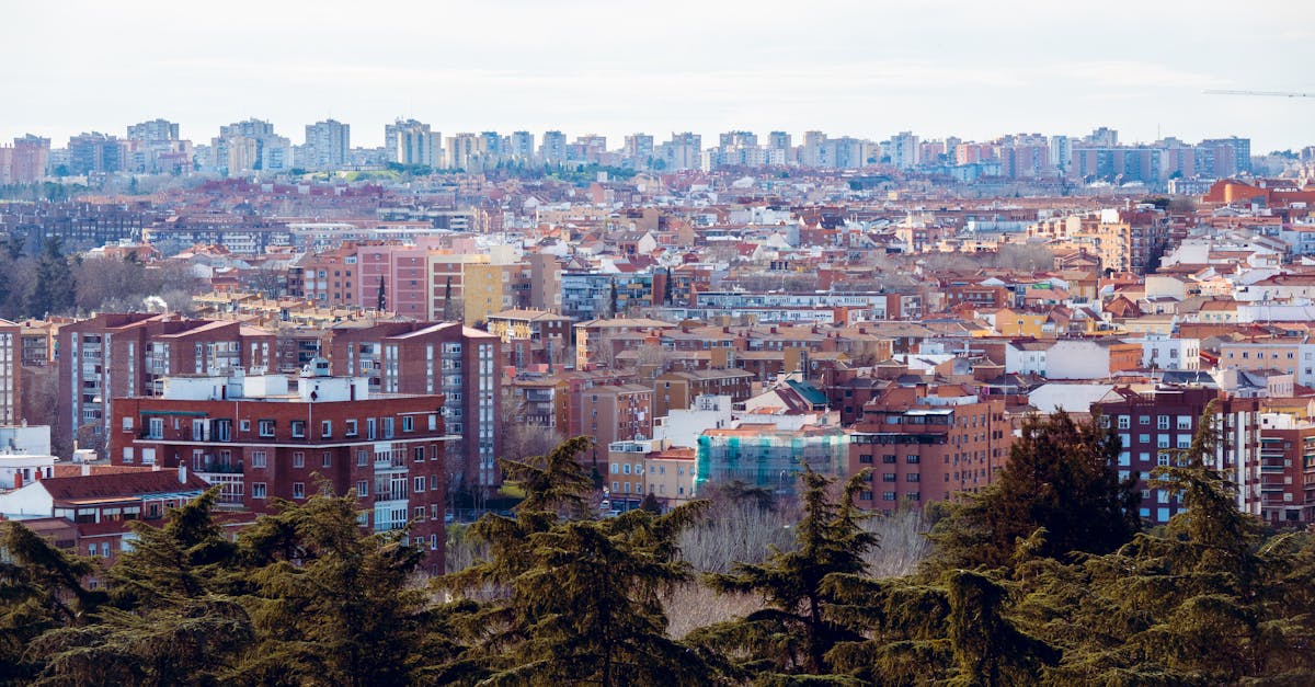 Aerial view of the vibrant cityscape of Madrid, showcasing diverse urban architecture under a clear sky.