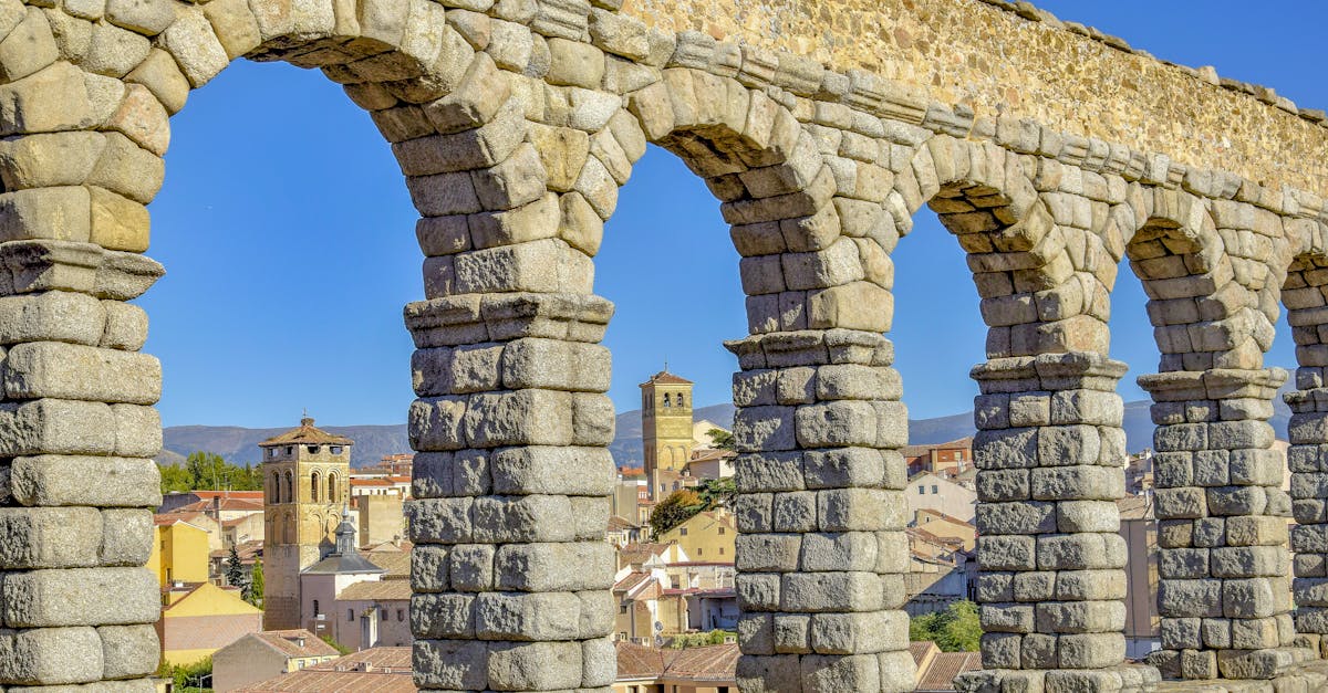 Iconic Roman aqueduct in Segovia with arches overlooking the cityscape.