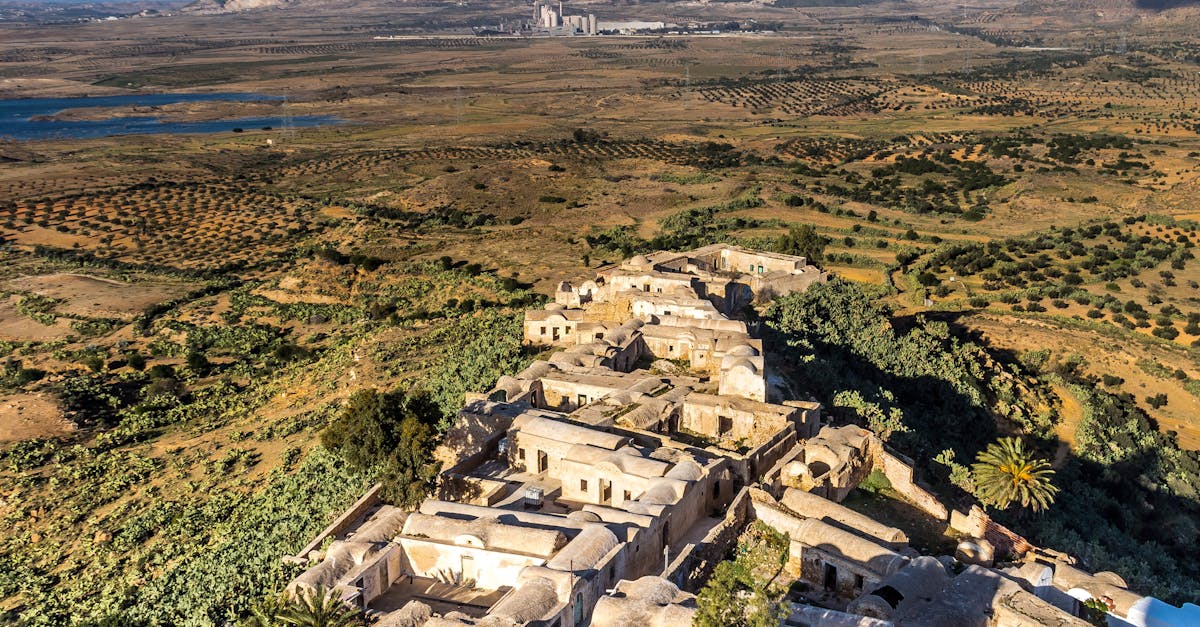 Explore the charming architecture of Takrouna village amidst vast Tunisian plains.