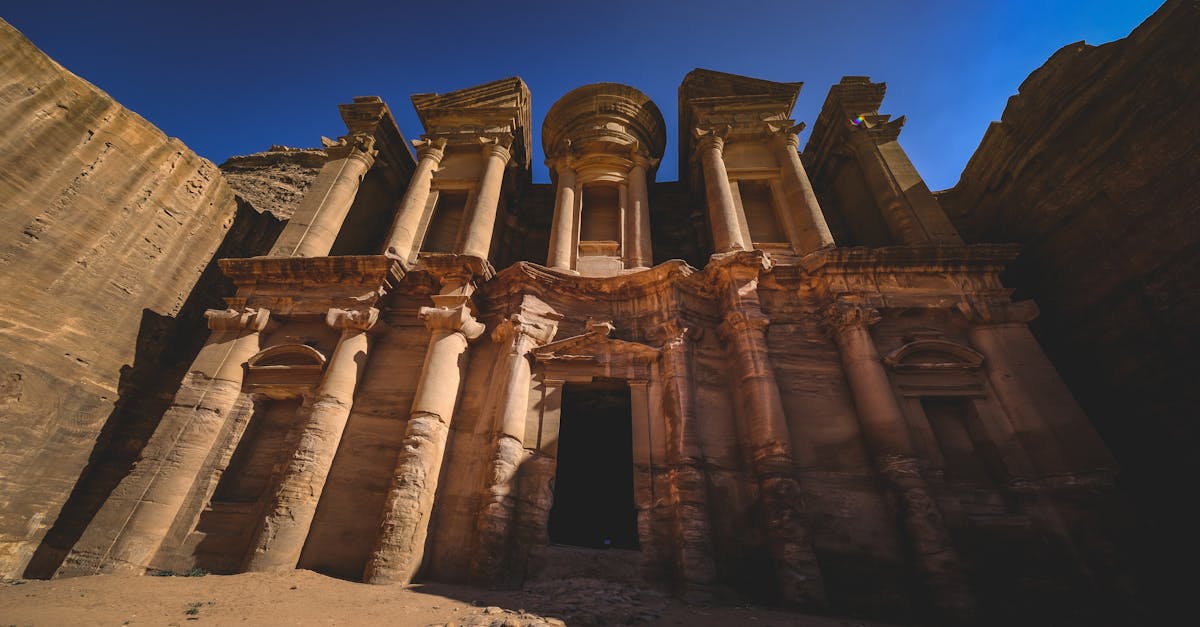 Explore the stunning facade of Ad Deir, an ancient monument carved into sandstone in Petra.