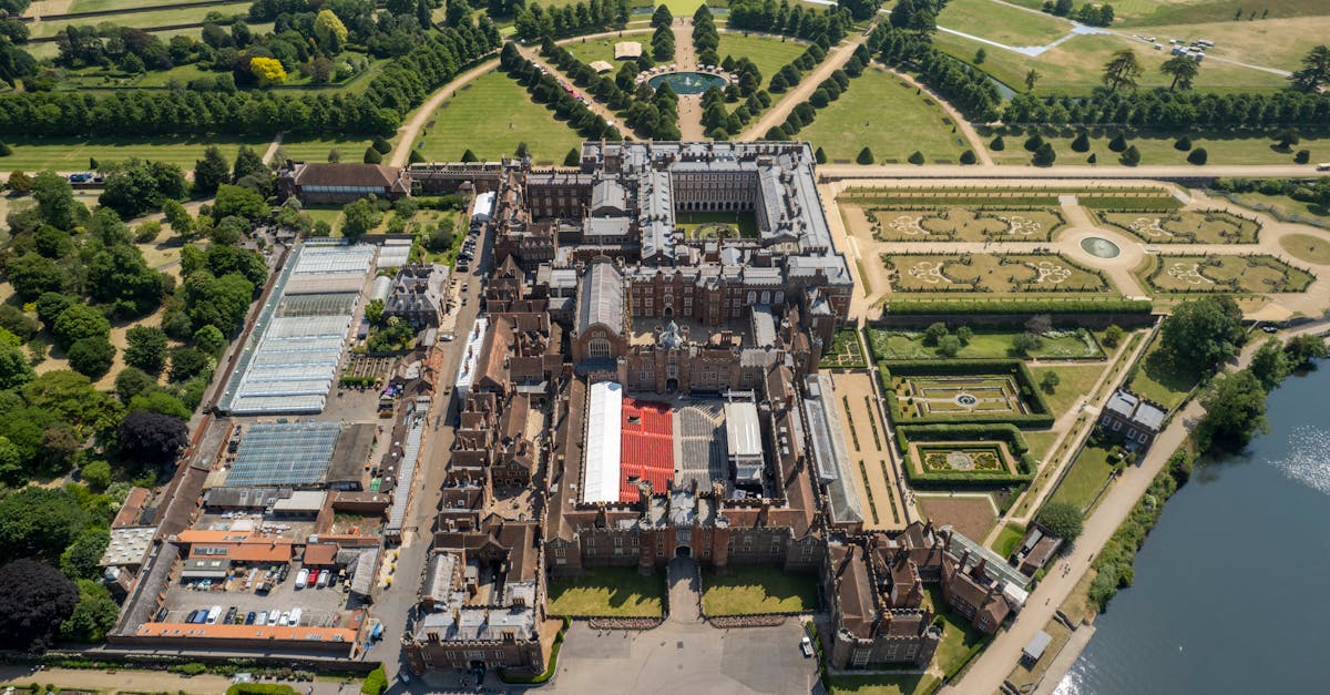 Stunning aerial view of Hampton Court Palace and gardens in England, showcasing its grandeur.