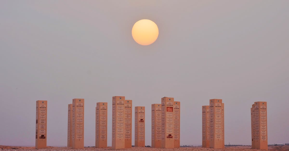 Mystical stone pillars stand in the Hazeva desert with a striking sunset.
