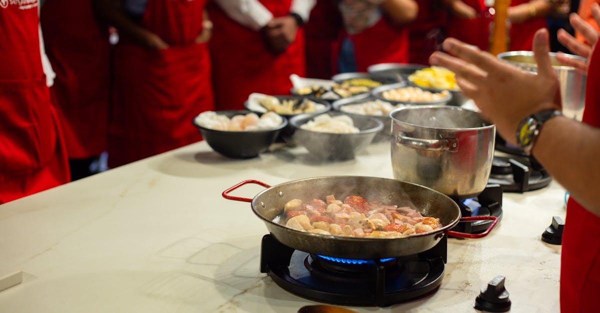 Participants learn cooking skills in a vibrant class setting, engaging with hands-on food preparation.