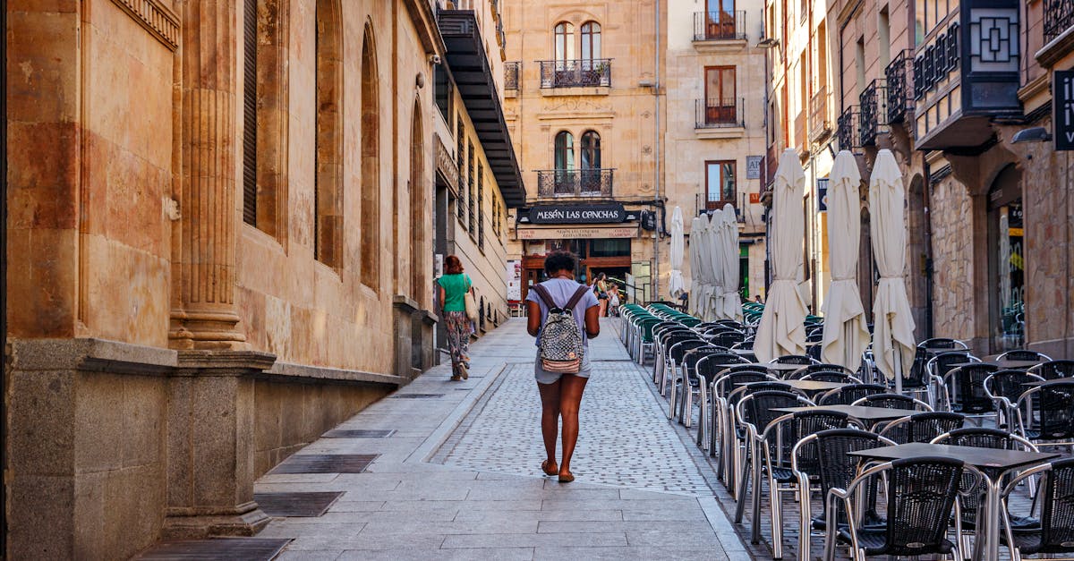 A scenic view of a woman walking down a quaint street in Salamanca, Spain.