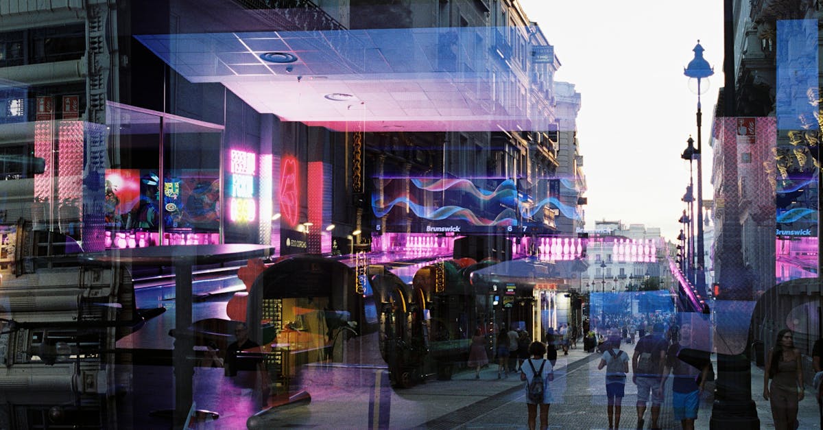 Colorful urban street with neon reflections and people walking at twilight.