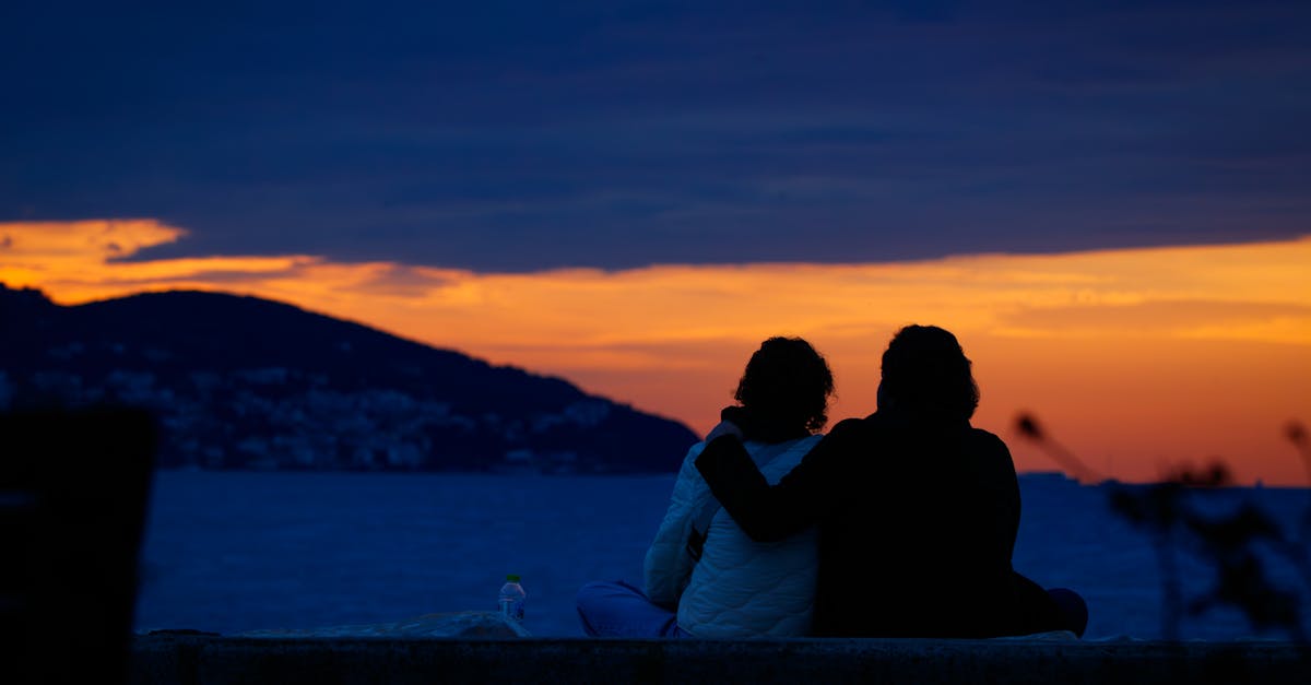 Couple enjoying a beautiful sunset over the sea in Istanbul. Perfect for travel and romance themes.