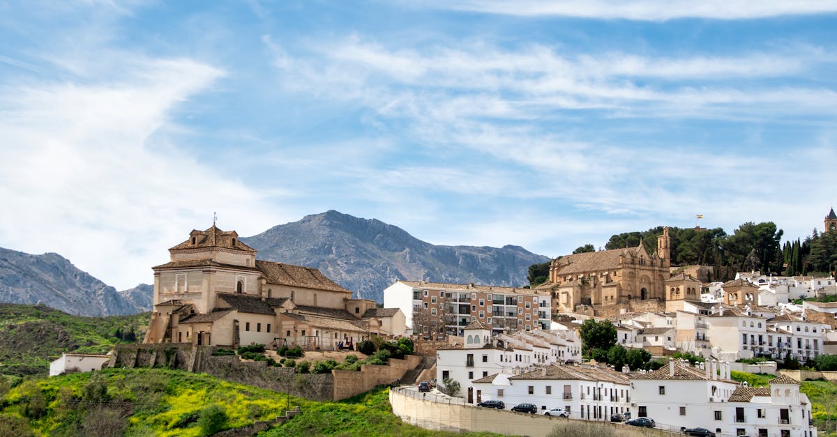 Beautiful landscape view of Antequera, Spain featuring Del Carmen Church and surrounding buildings.