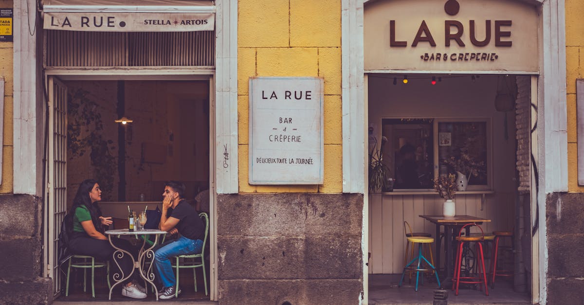 Casual outdoor café setting in Madrid featuring two people enjoying a drink.