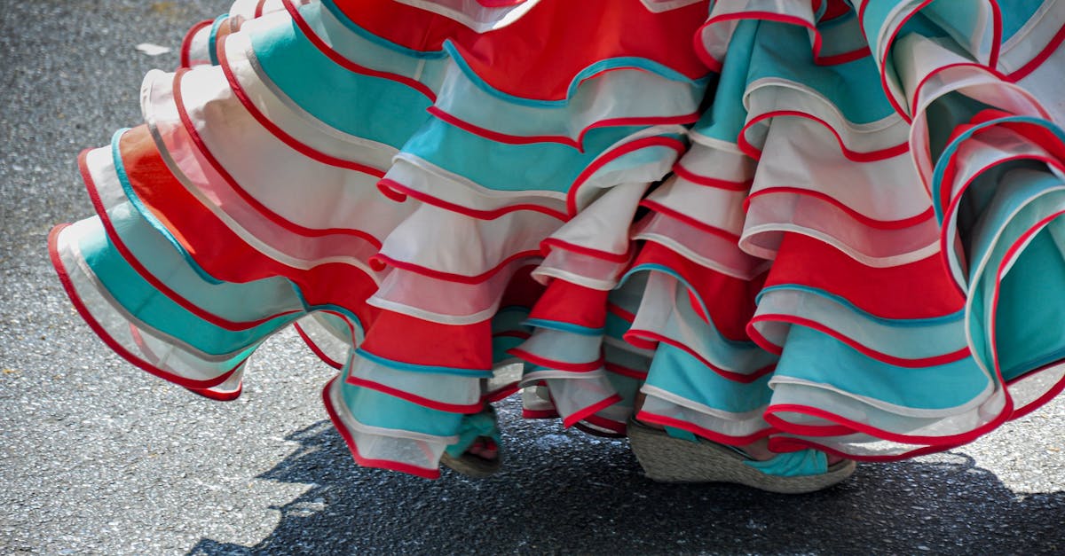 A vibrant flamenco skirt in red, teal, and white, captures traditional dance motion.