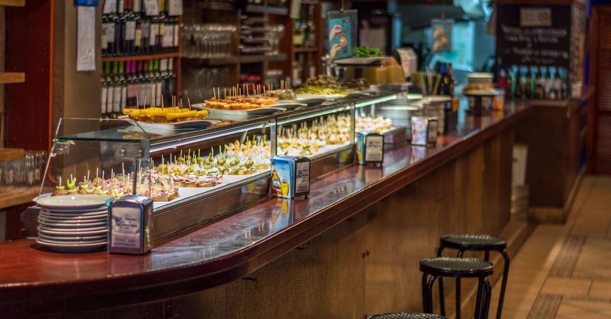 Explore a vibrant tapas bar in Barcelona with a wide selection of pinchos on display.