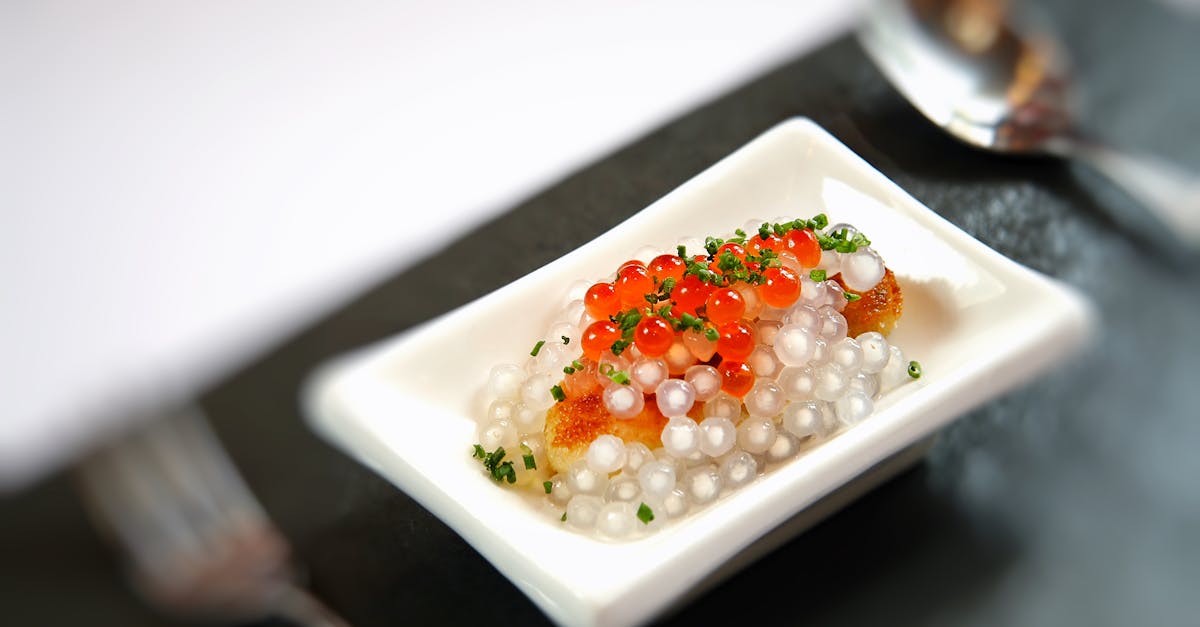 Luxurious gourmet caviar dish served on a small plate with artistic presentation in fine dining setting.