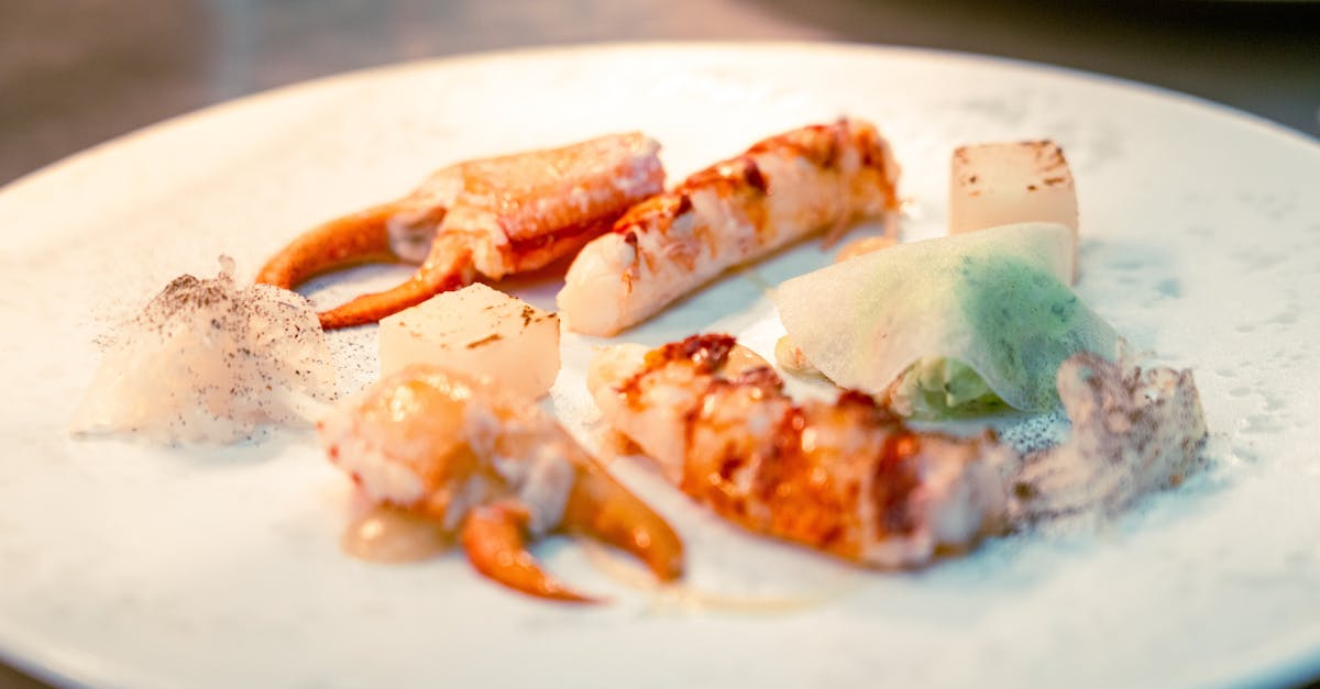 Elegant seafood dish featuring crab claws, lobster, and creative plating, ideal for fine dining contexts.