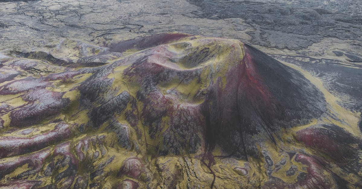 Striking aerial shot showcasing a vibrant volcanic landscape with unique red and yellow hues.