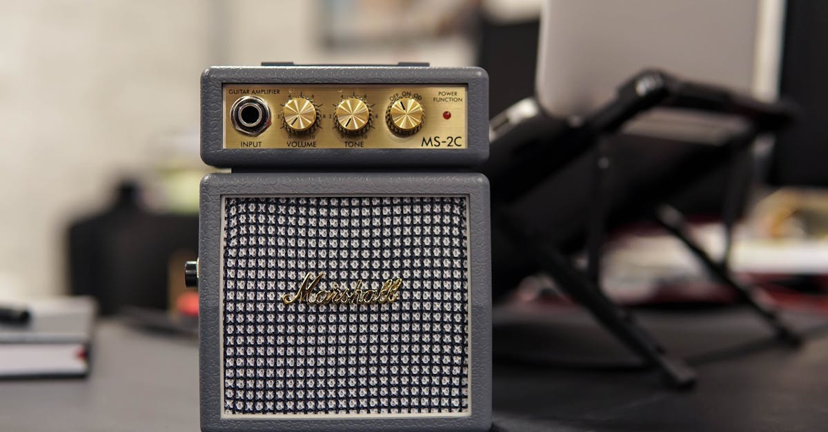 Marshall MS-2C mini guitar amplifier on a desk with blurred office background.