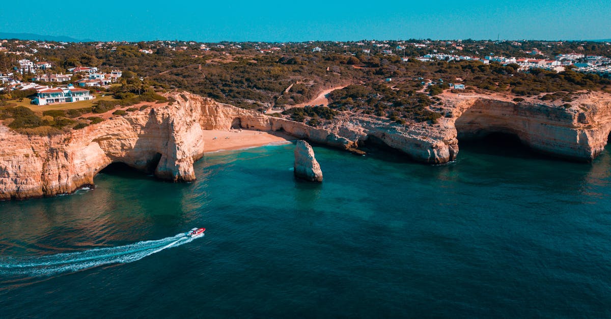 Stunning aerial view of Algarve's cliffs and turquoise sea in Portugal.