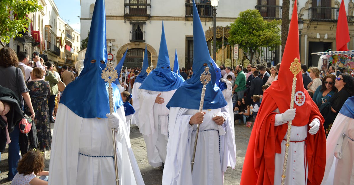 Colorful traditional procession with participants in robes and hoods in Seville, Spain.