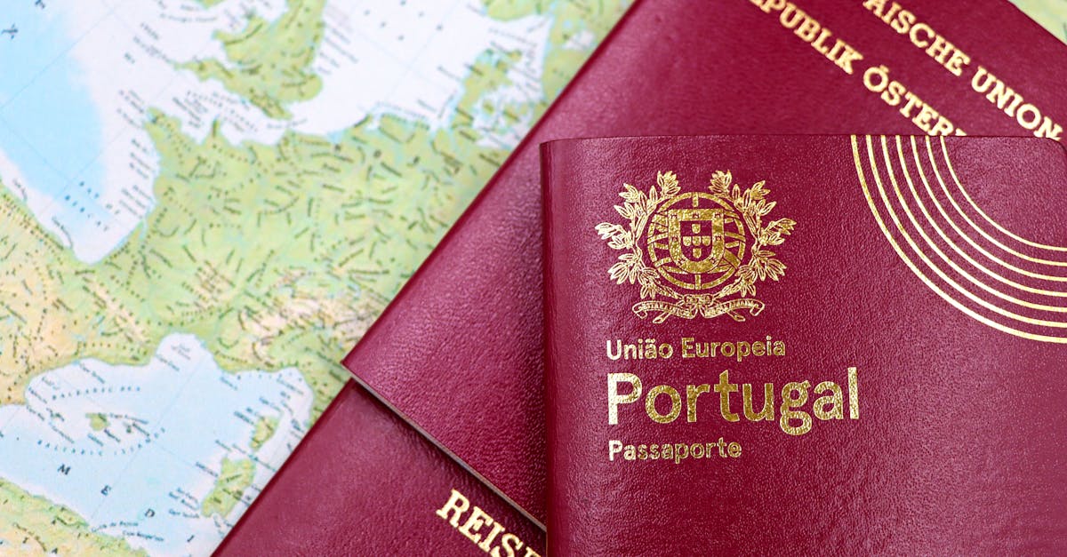 Close-up of Portuguese and Austrian passports lying on a map of Europe, symbolizing travel and mobility.