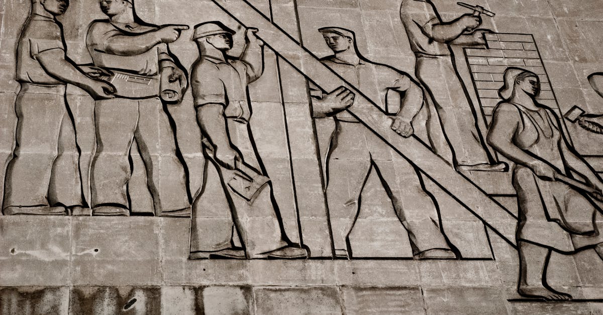 A detailed view of a Soviet-era relief sculpture depicting workers in Budapest, Hungary.