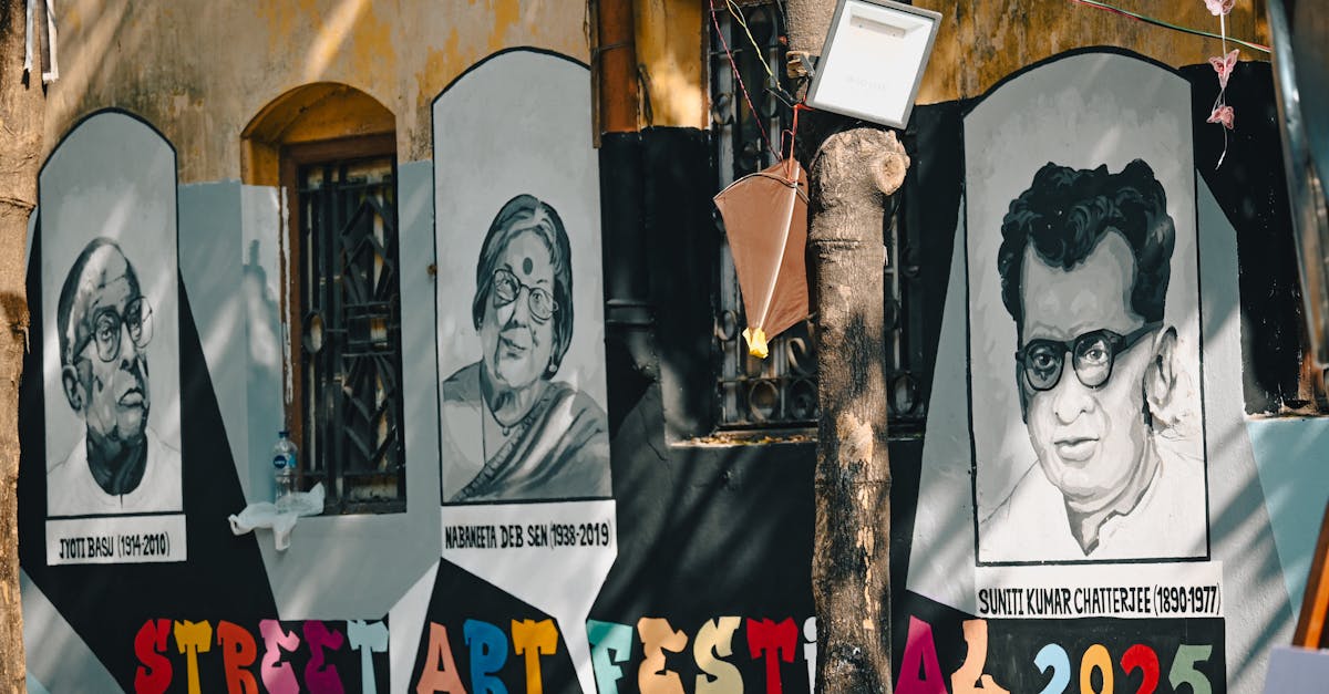 Vibrant street art mural depicting famous figures at a festival in Kolkata, India.
