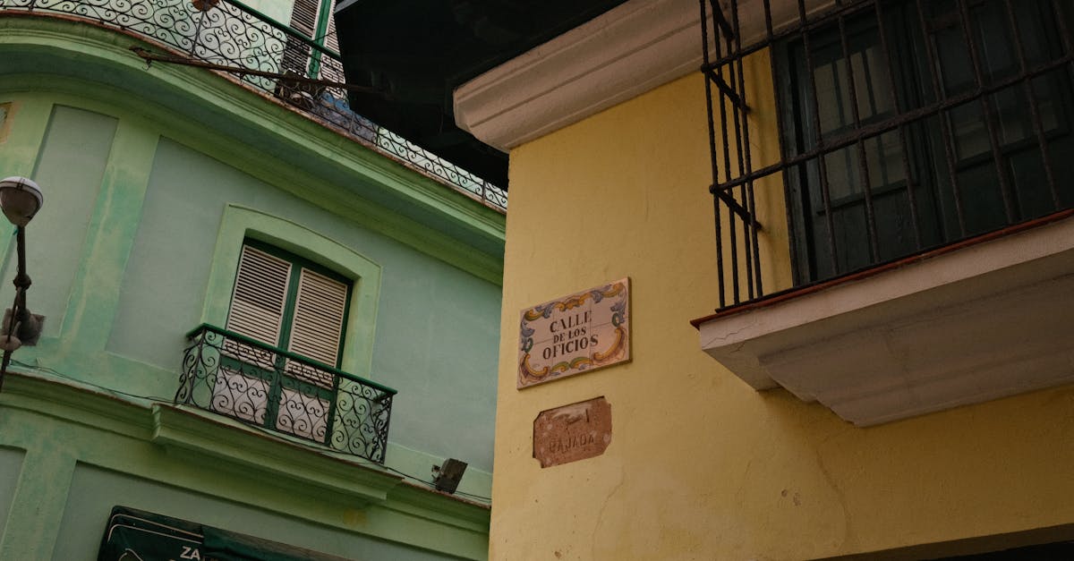 Vibrant Spanish colonial buildings on Calle de Los Oficios in a sunlit street corner.