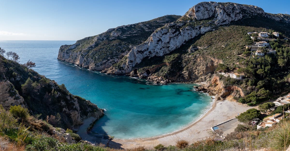 Explore the stunning coastline of Jávea, Spain with this picturesque cove and beach.