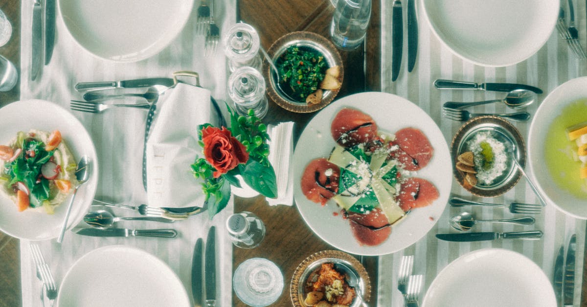 Overhead view of an elegant table setup featuring various gourmet dishes and elegant tableware.