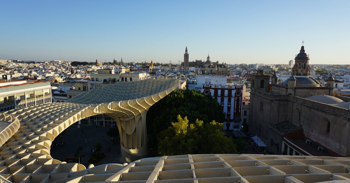 Panoramic view of Metropol Parasol and Seville skyline at sunset with historical landmarks.