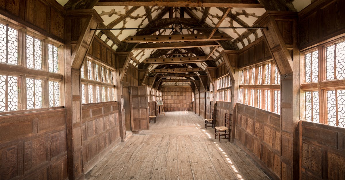 Wooden corridor with intricate timber frame, capturing historic English architecture.