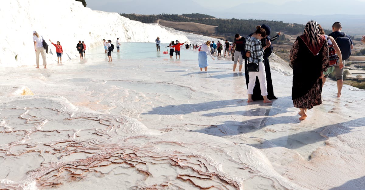 Visitors enjoying the natural travertine terraces of Pamukkale, Turkey, a stunning World Heritage site.