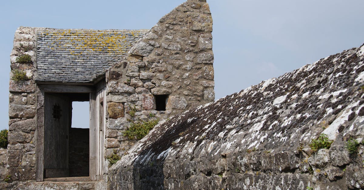 Close-up of a historic stone building with weathered textures in Brittany, France.