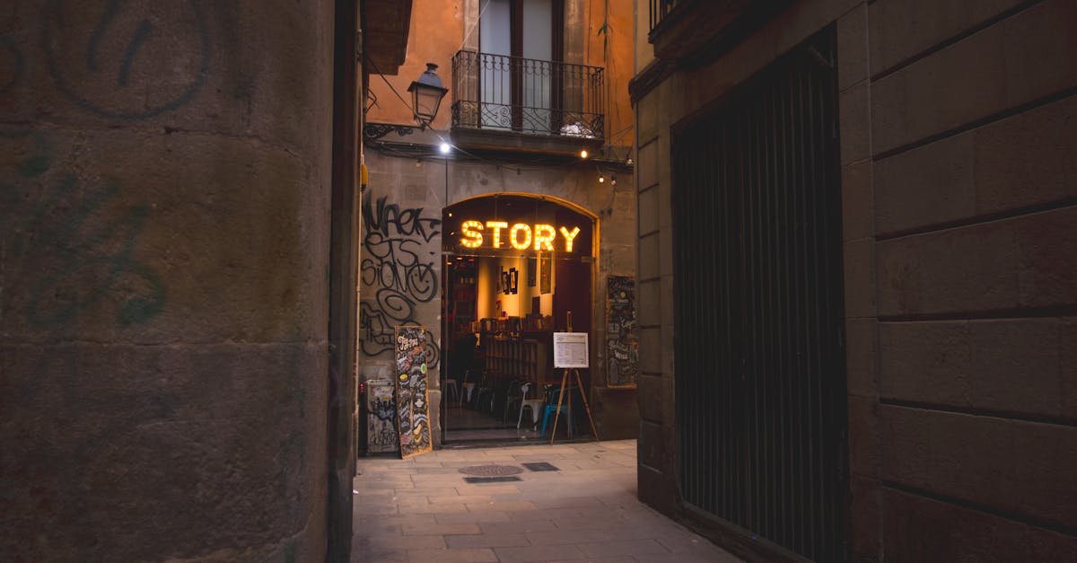 Charming alleyway café with a vintage sign and urban graffiti in a quaint European setting.