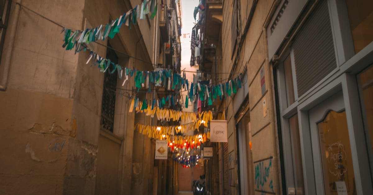 A vibrant alleyway with decorative bunting and warm lighting in a historic urban setting.