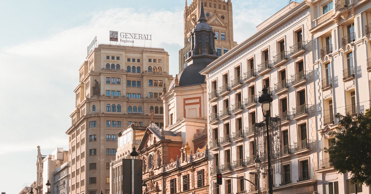 A sunny street scene in Madrid showcasing historic architecture and modern buildings.