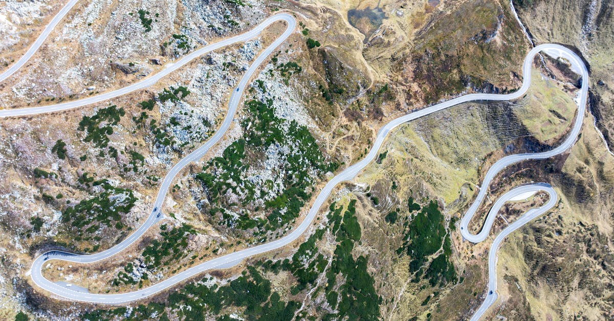 Aerial view of a winding road through mountainous terrain in Carinthia, Austria.